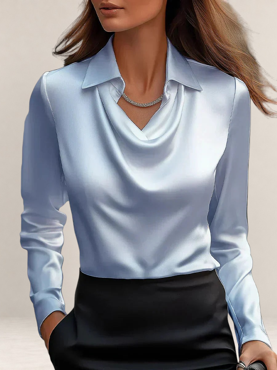 Valvet Oak House elegant white satin blouse with a draped neckline and long sleeves worn with black trousers