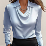 Valvet Oak House elegant white satin blouse with a draped neckline and long sleeves worn with black trousers