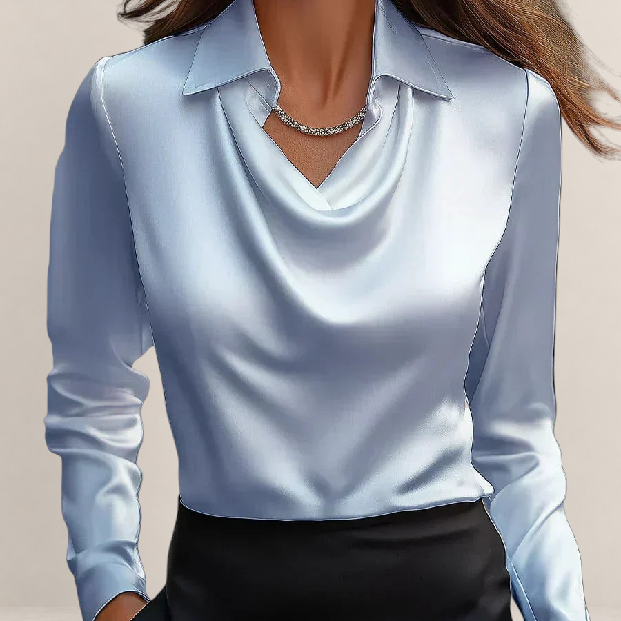 Valvet Oak House elegant white satin blouse with a draped neckline and long sleeves worn with black trousers