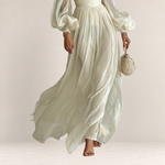 Valvet Oak House romantic white maxi dress with airy long sleeves and flowing skirt, perfect for elegant occasions.