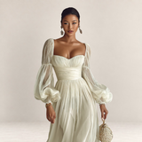 Valvet Oak House romantic cream maxi dress with sheer puff sleeves and a sweetheart neckline on a model