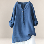 Valvet Oak House Edna blue linen and cotton blend blouse with a V-neck and button-down front, hanging on a hanger.