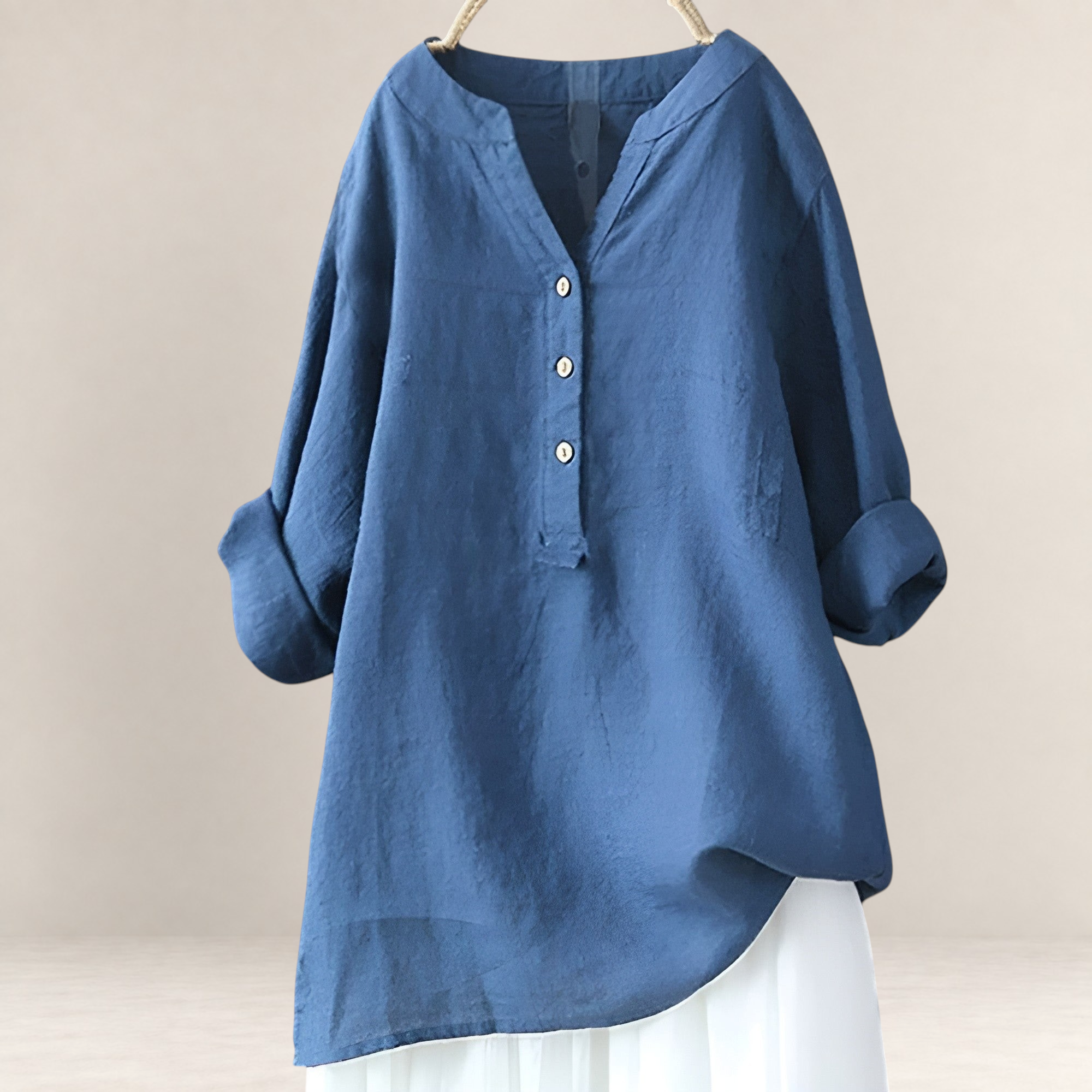 Valvet Oak House Edna blue linen and cotton blend blouse with a V-neck and button-down front, hanging on a hanger.