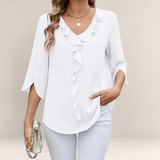 Valvet Oak House white blouse featuring a V-neckline with romantic ruffles and elegant three-quarter length sleeves.