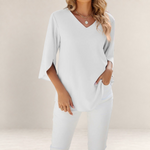 Valvet Oak House white blouse with a V-neck and 3/4 length flared sleeves worn with matching white trousers