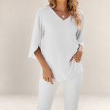 Valvet Oak House white blouse with a V-neck and 3/4 length flared sleeves worn with matching white trousers