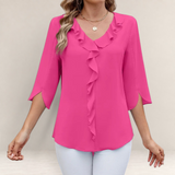 Valvet Oak House fuchsia pink blouse with ruffled V-neckline and 3/4 sleeves worn by a woman