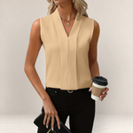 Valvet Oak House beige sleeveless blouse with a deep V-neckline and relaxed fit worn by a woman