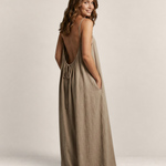 Valvet Oak House Safira beige maxi summer dress with thin straps, open back, and A-line silhouette on a smiling model