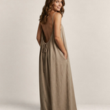 Valvet Oak House Safira beige maxi summer dress with thin straps, open back, and A-line silhouette on a smiling model