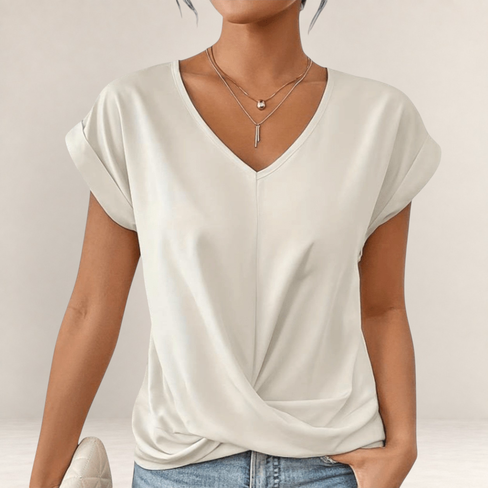 Valvet Oak House cream V-neck t-shirt with short cuffed sleeves and a flattering draped front hem design.