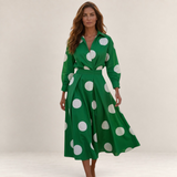 Valvet Oak House Lana green cotton midi dress with white polka dots, long sleeves, and a classic collar on a model.