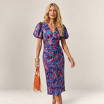 Valvet Oak House Cleide midi dress with V-neck, puff sleeves, and vibrant abstract print on a blonde model