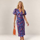 Valvet Oak House Cleide midi dress with V-neck, puff sleeves, and vibrant abstract print on a blonde model